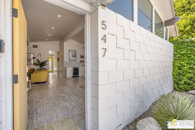 a view of a patio with dining table and chairs