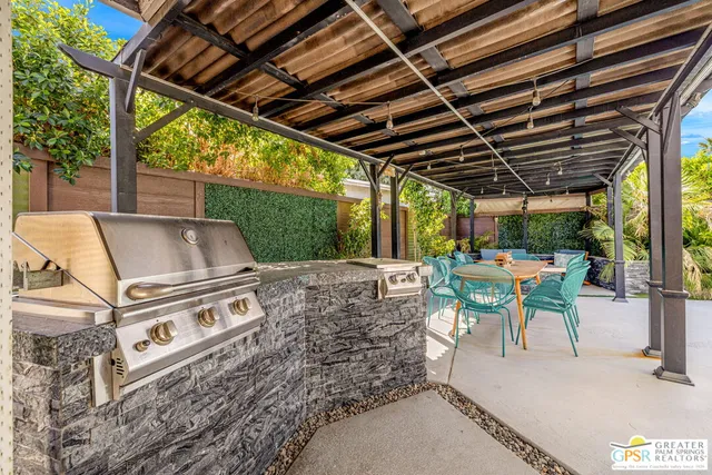a view of patio with table and chairs and potted plants
