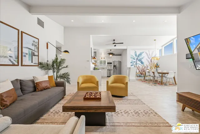 a living room with furniture rug and wooden floor