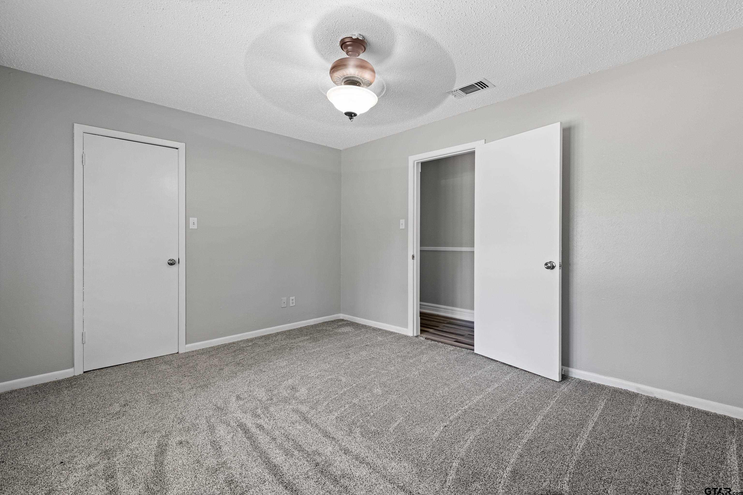 1821 Azalea Street Gilmer, TX 75644 - Photo 20 of 34 a view of an empty room with a ceiling fan