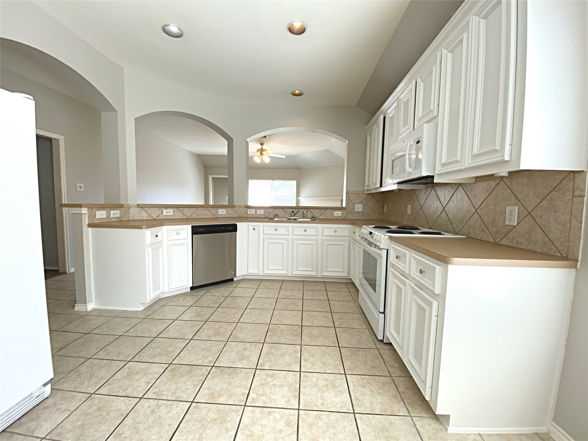 22014 Gold Leaf Trail Cypress, TX 77433 - Photo 11 of 25 a kitchen with a sink a stove top oven and cabinets
