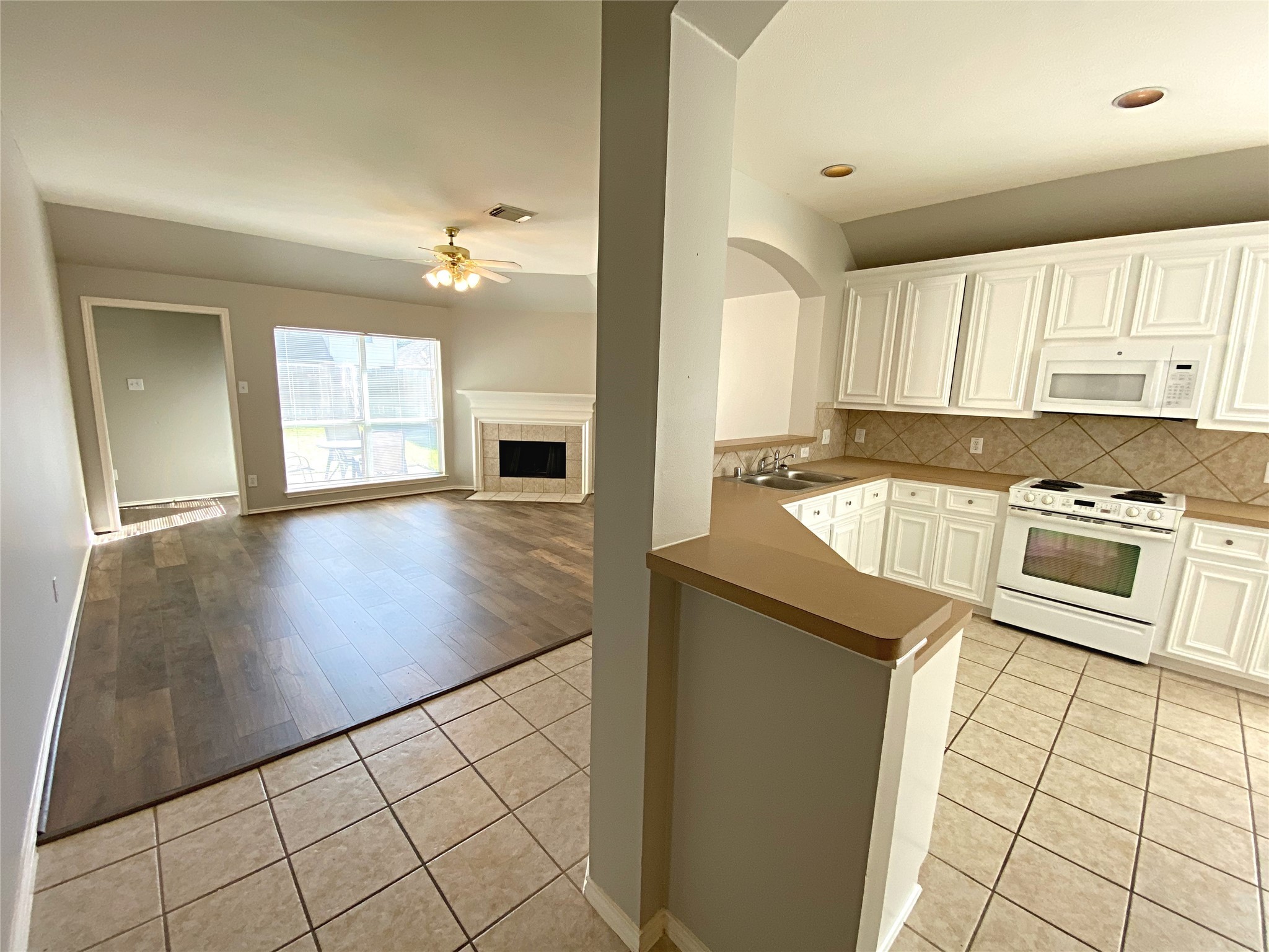 22014 Gold Leaf Trail Cypress, TX 77433 - Photo 13 of 25 a kitchen with stainless steel appliances granite countertop a refrigerator a stove and white cabinets