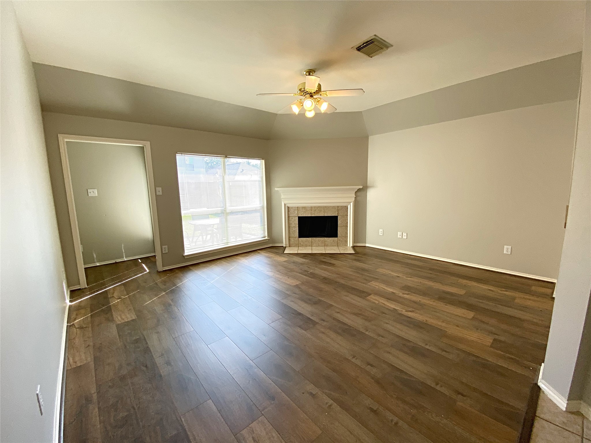 22014 Gold Leaf Trail Cypress, TX 77433 - Photo 15 of 25 wooden floor in an empty room with a fireplace