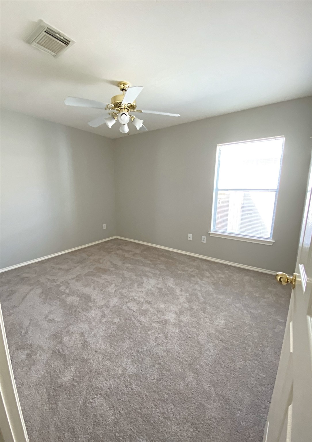 22014 Gold Leaf Trail Cypress, TX 77433 - Photo 20 of 25 an empty room with a window and ceiling fan