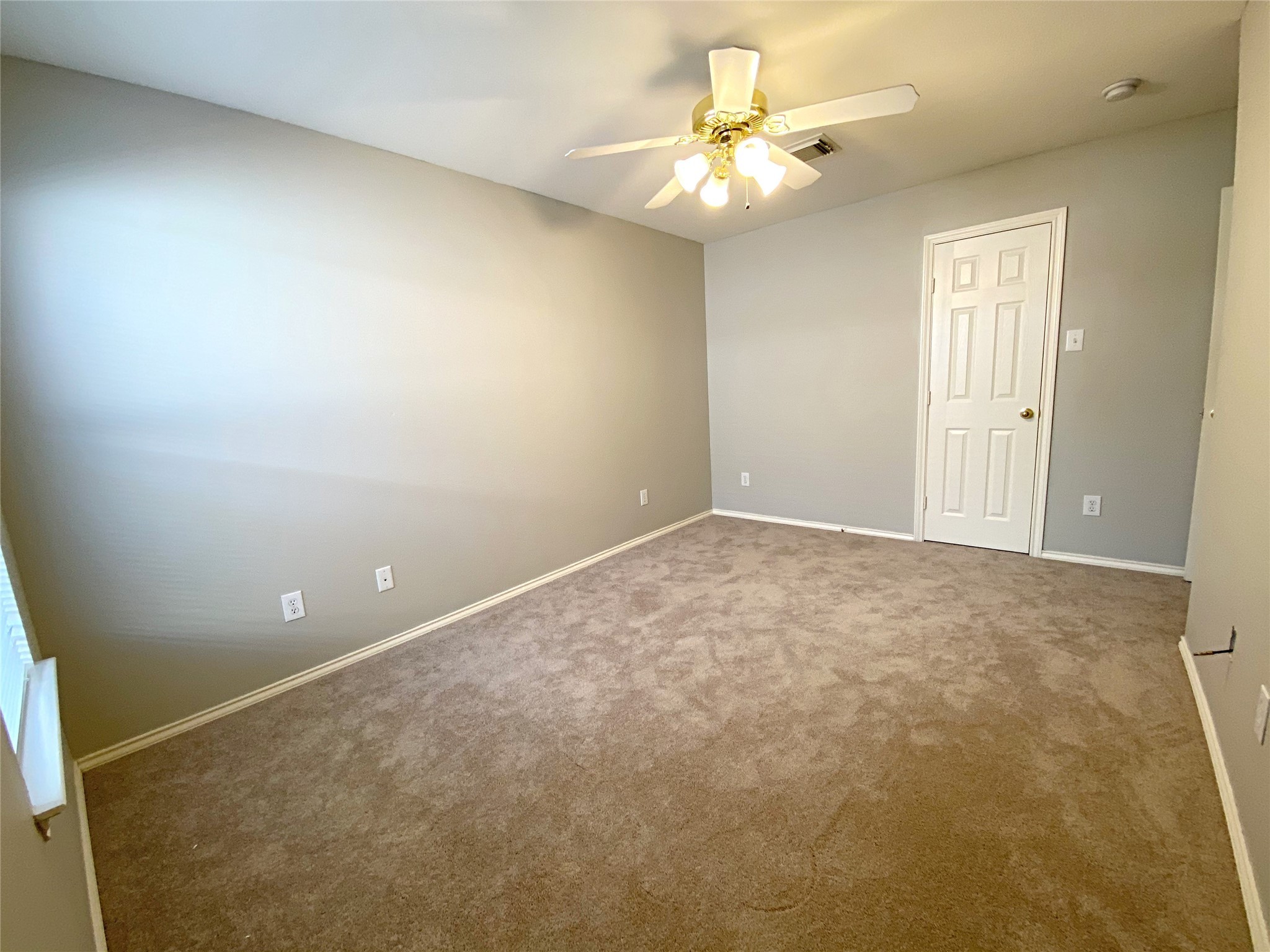 22014 Gold Leaf Trail Cypress, TX 77433 - Photo 22 of 25 an empty room with a chandelier fan and windows