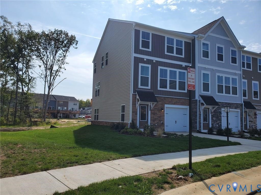 8833 Foxway Ridge Lane Glen Allen, VA 23060 - Photo 25 of 27 a view of a brick building next to a yard