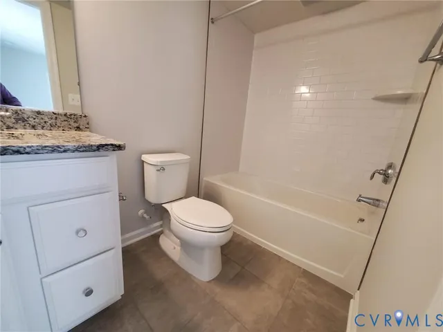 a white toilet sitting next to a bath tub