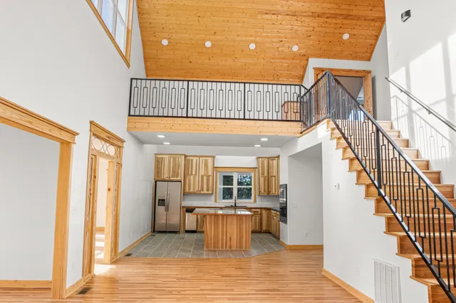 a kitchen with stainless steel appliances granite countertop a stove a sink and a refrigerator