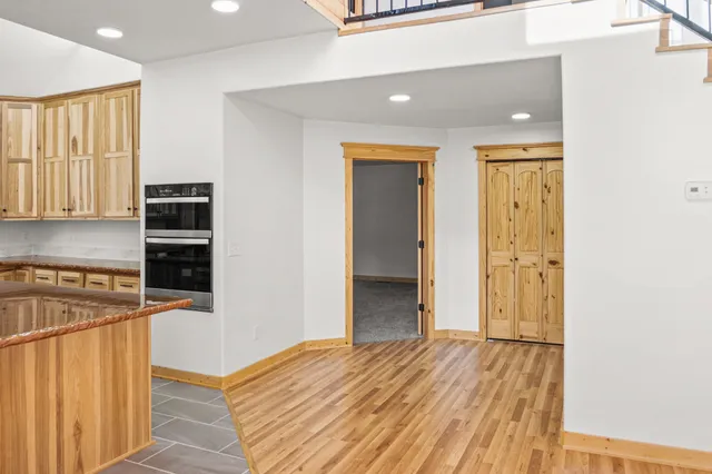 a view of a livingroom with wooden floor and windows
