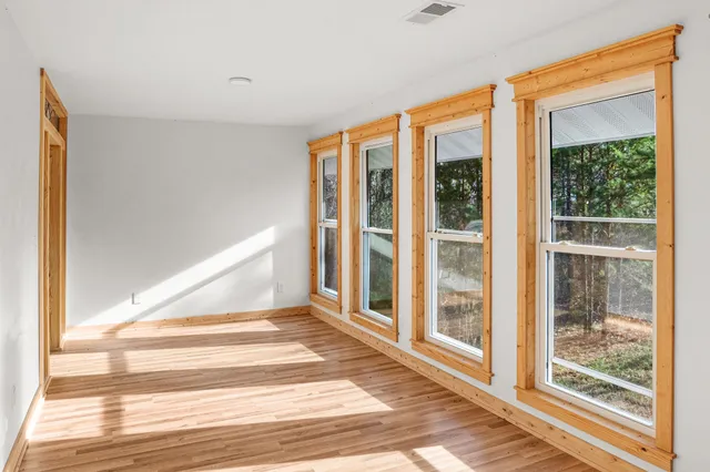 a view of staircase with railing and white walls
