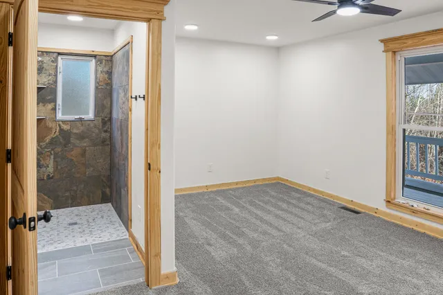 a view of an empty room and a window