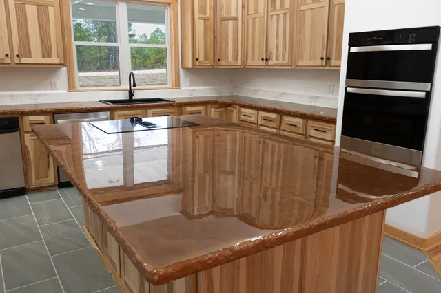 a kitchen with stainless steel appliances granite countertop a sink a stove and a microwave