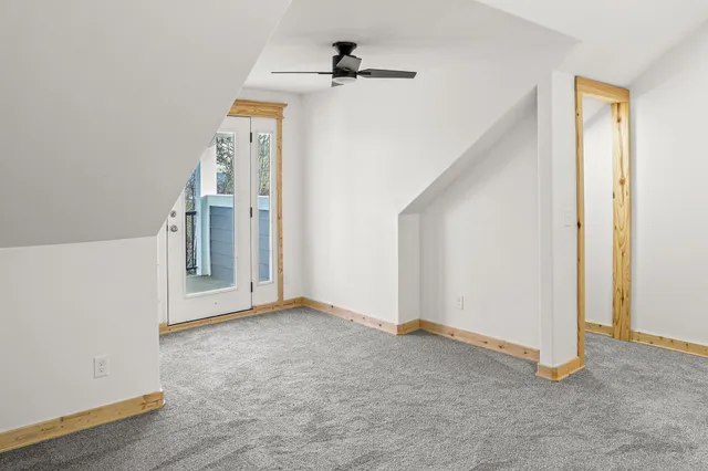 a view of a house with a yard and covered with trees