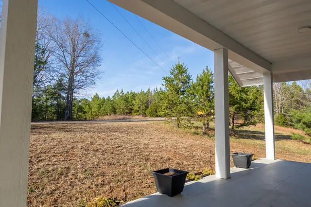 a front view of a house with yard and seating space