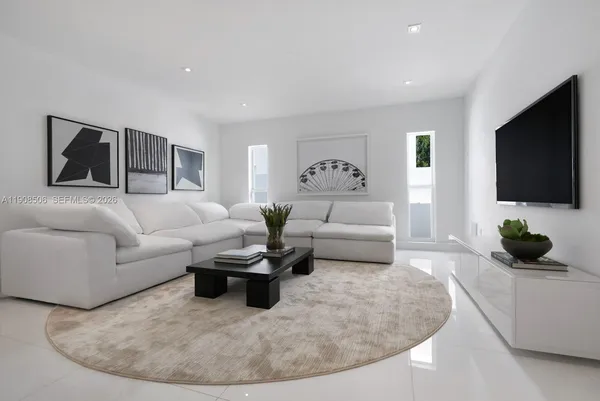 a living room with furniture and a flat screen tv
