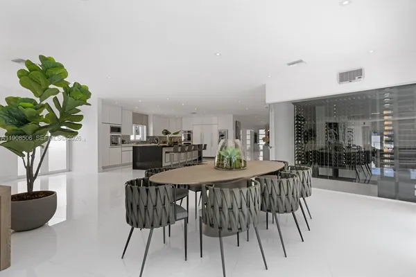 a view of a dining room with furniture and a potted plant