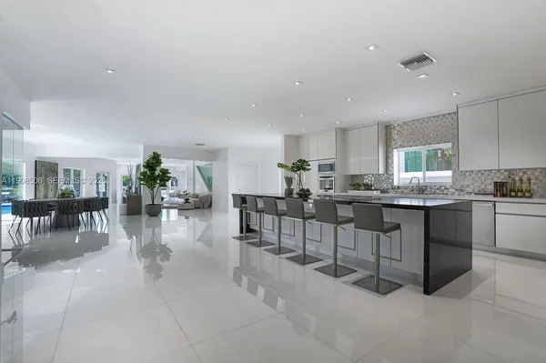 a kitchen with lots of counter top space and dining table