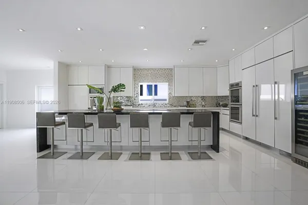 a kitchen with stainless steel appliances granite countertop a refrigerator and a stove top oven