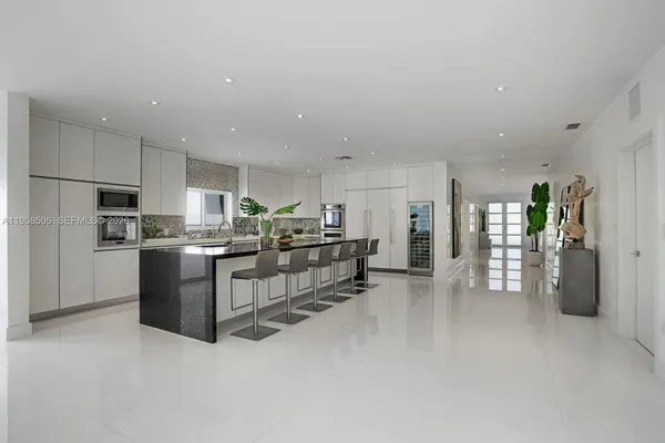 a kitchen with stainless steel appliances kitchen island lots of white cabinets