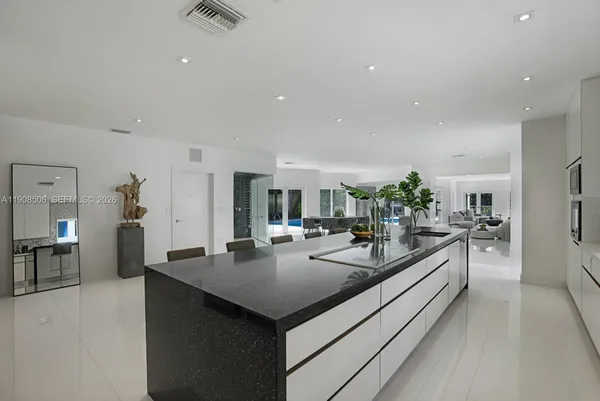a kitchen with sink refrigerator and dining table