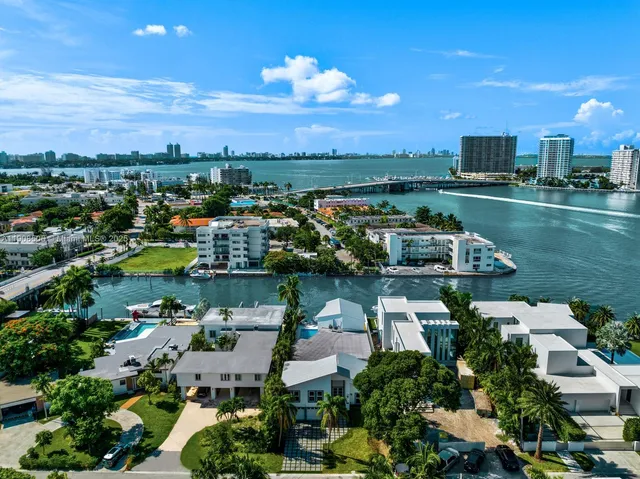 a view of a dining room with furniture and a potted plant