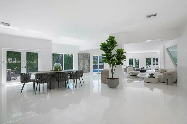 a living room with furniture and a potted plant