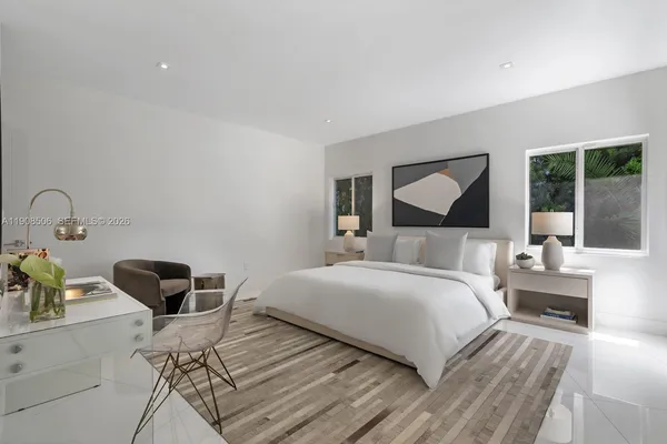 a bedroom with a bed and a large window