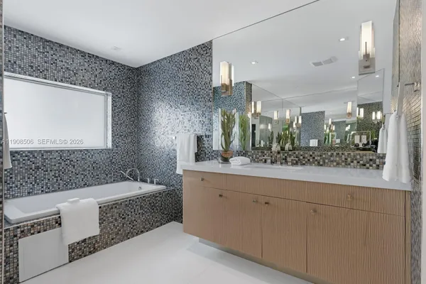 a bathroom with a bathtub and a sink