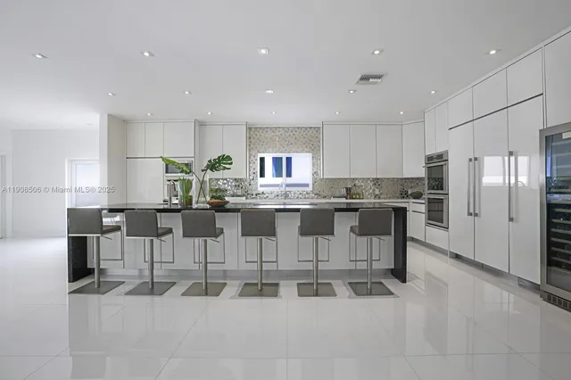 a kitchen with stainless steel appliances kitchen island lots of white cabinets