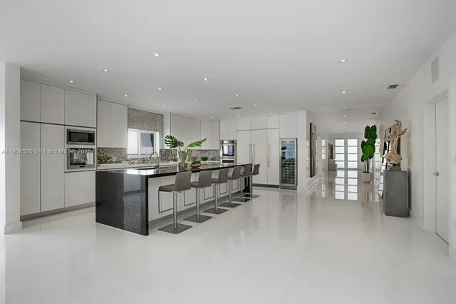 a kitchen with sink refrigerator and dining table