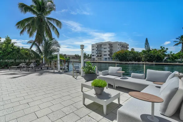 a view of a patio with couches and a table and chairs