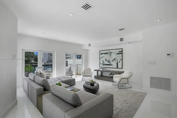 a living room with furniture and large window