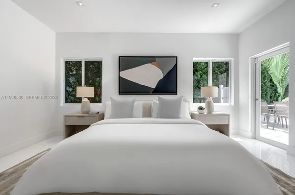 a bedroom with a large bed and a large window