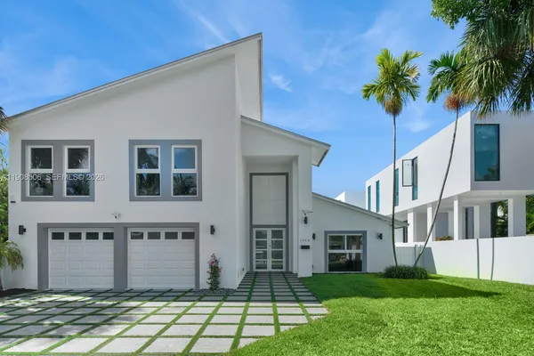 a front view of a house with a garden