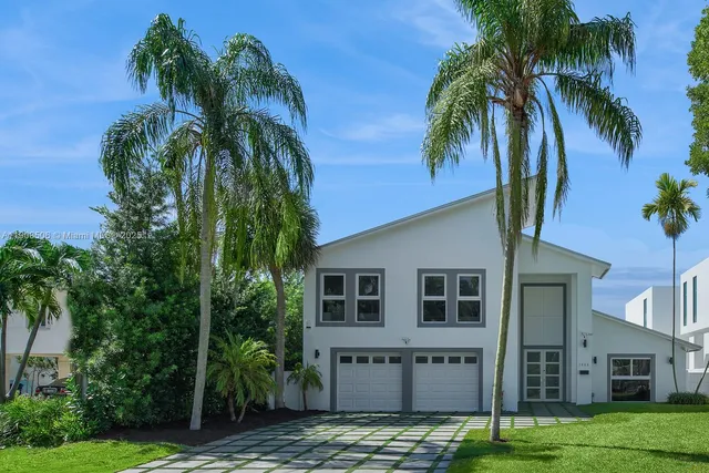 a view of a house with a palm tree