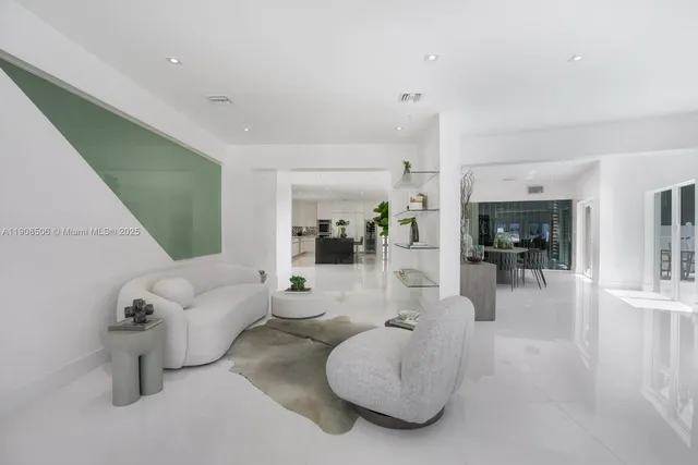 a bedroom with furniture and a large window