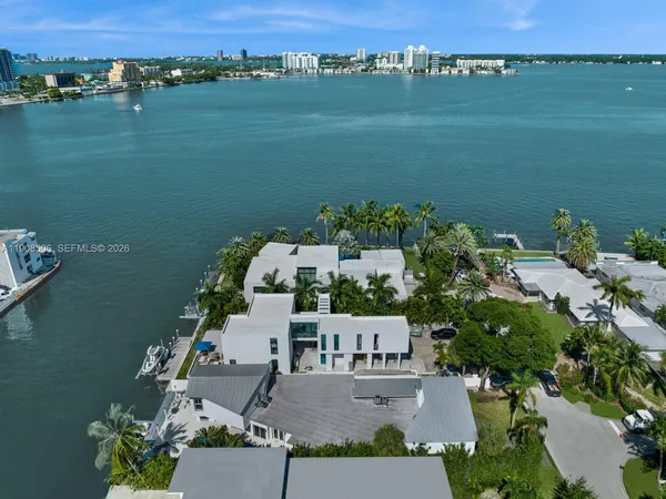 an aerial view of a house with a lake view