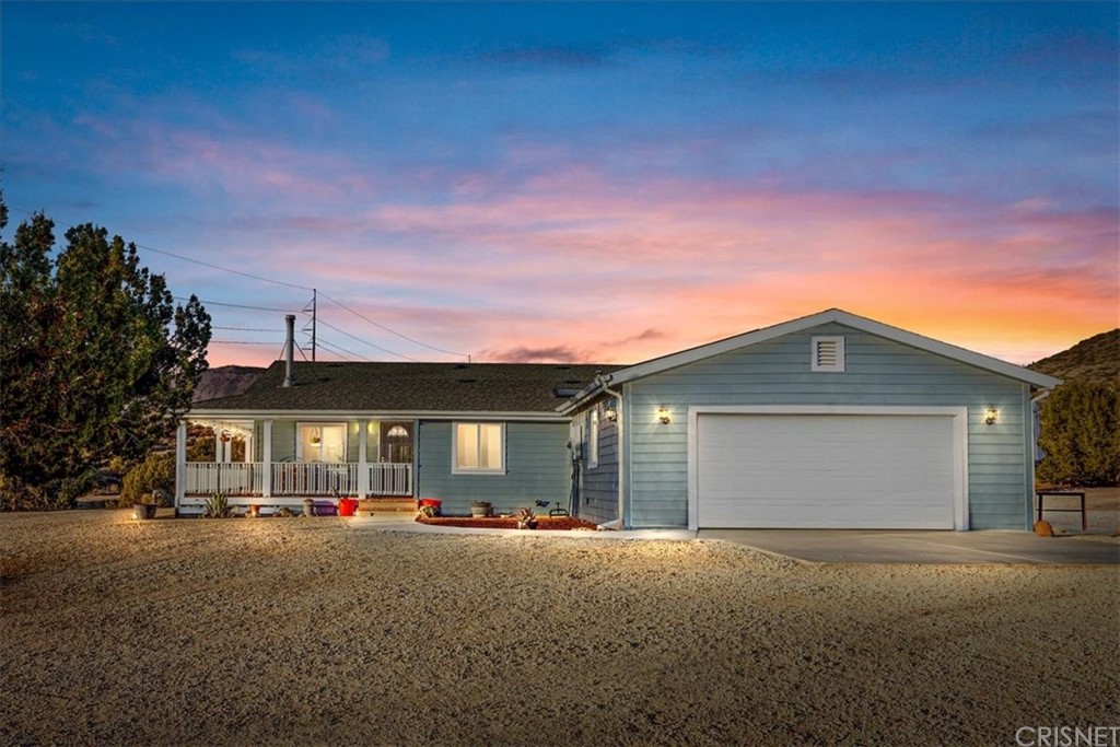 24608 Transvaal Road Tehachapi, CA 93561 - Photo 1 of 1 a front view of a house with a garage and a yard