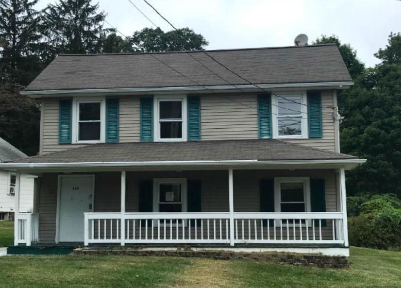 a view of a brick house with a window in front of a house