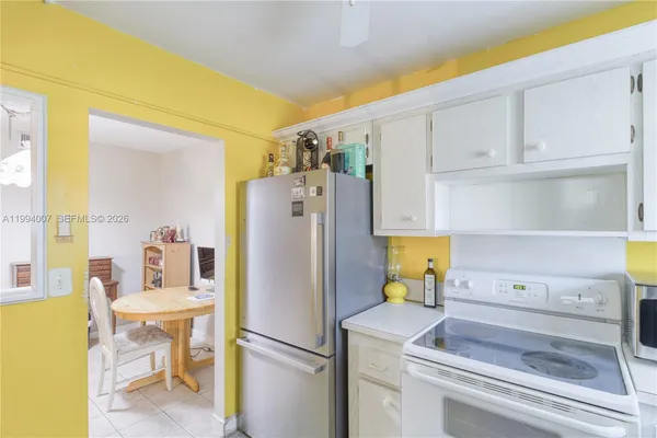 a kitchen with a refrigerator and cabinets