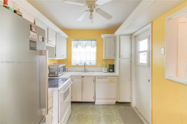 a kitchen with a sink cabinets and window