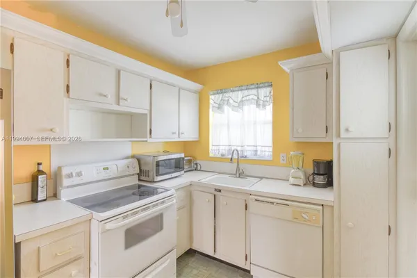 a kitchen with a sink stove and cabinets
