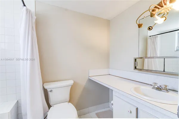 a white toilet sitting next to a bathroom sink