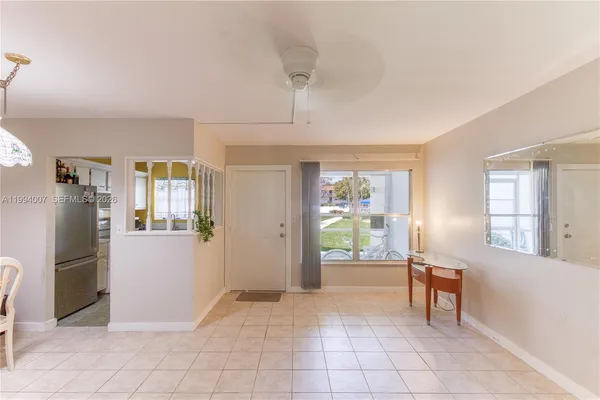 a view of a kitchen with furniture and a refrigerator