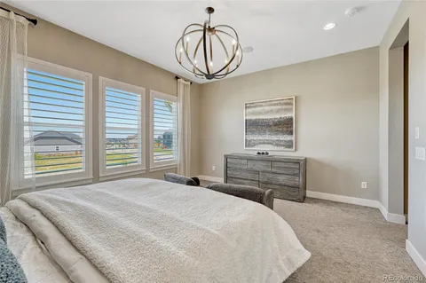 a bedroom with a bed and a chandelier