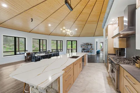 a room with furniture a rug and white walls