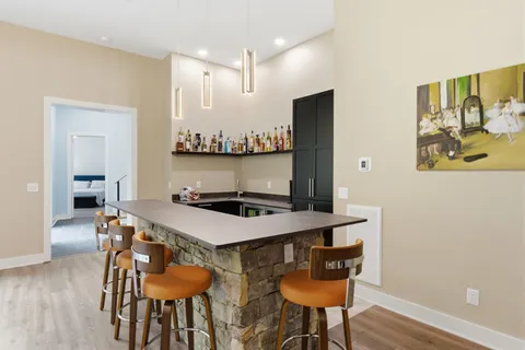 a living room with furniture ceiling fan and a rug