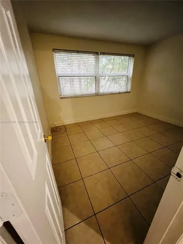 a view of a wooden door and a window