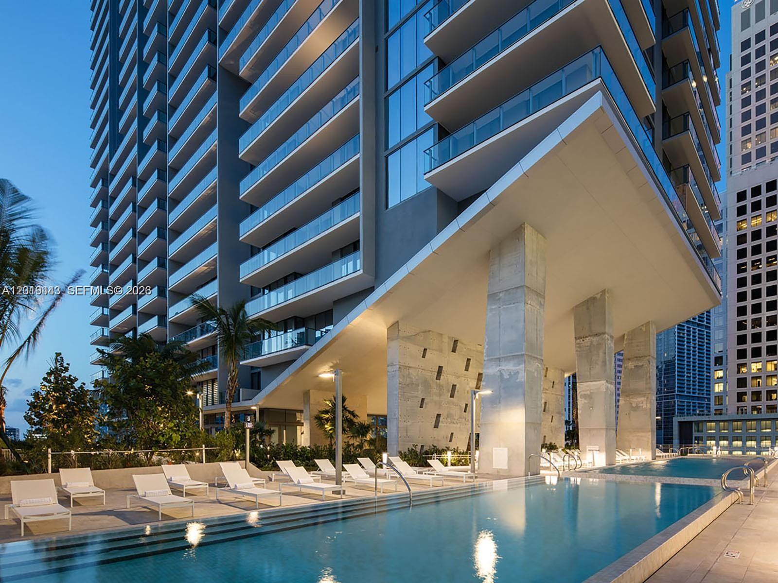 68 Southeast 6th Street, Unit 2702 Miami, FL 33131 - Photo 16 of 28 a view of a swimming pool with outdoor seating