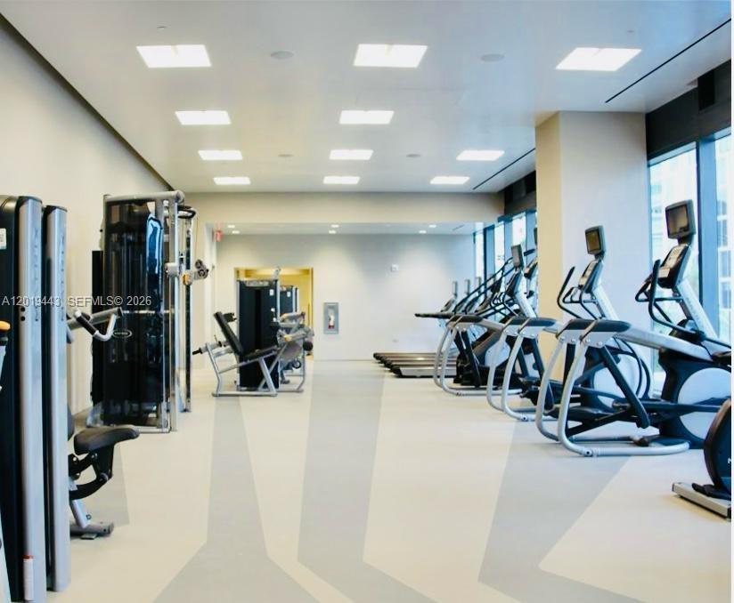68 Southeast 6th Street, Unit 2702 Miami, FL 33131 - Photo 25 of 28 a view of a room with gym equipment